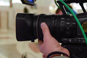 camera man adjusting video camera